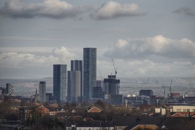 Modern buildings in city against sky