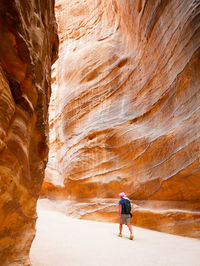 Rear view of man standing on rock