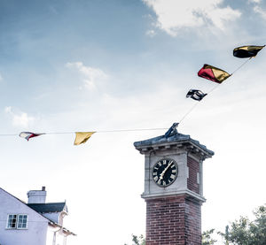 Low angle view of flags hanging against sky