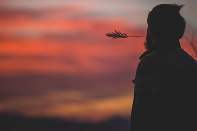 Silhouette of woman at sunset