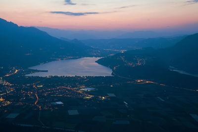 Aerial view of city lit up at night