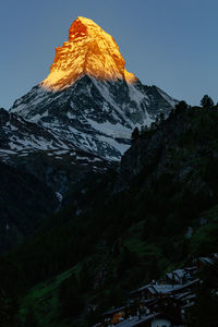 Scenic view of snowcapped mountains against clear sky