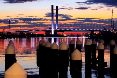 Illuminated westgate bridge against dramatic sky during sunset