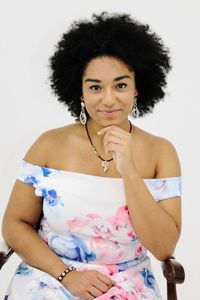 Portrait of smiling young woman against white background