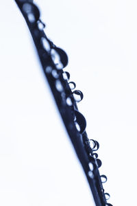 Close-up of chain on table against white background