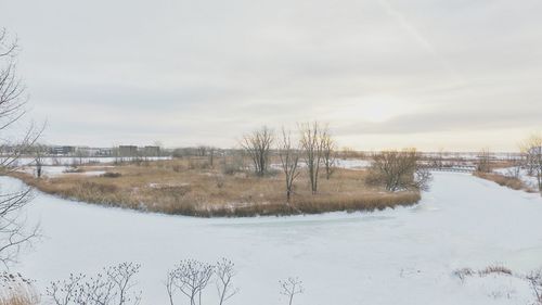 Scenic view of frozen lake against sky during winter