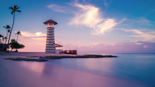 Lughthouse at sunrise at bayahibe beach with smooth water, la romana, dominican republic