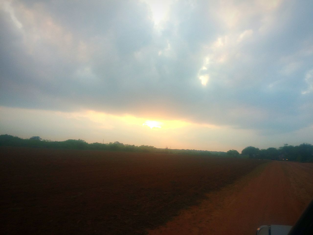 sky, landscape, sunset, cloud - sky, tranquil scene, scenics, tranquility, beauty in nature, nature, cloudy, field, sun, cloud, sunbeam, horizon over land, sunlight, idyllic, outdoors, rural scene, road