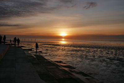 Scenic view of beach against sky during sunset