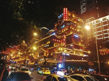 Illuminated city street and buildings at night