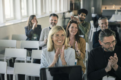 Group of business people attending presentation during conference