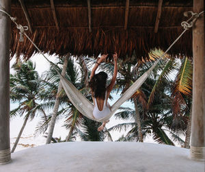 Rear view of woman on hammock