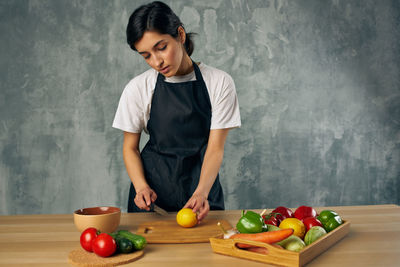 Young man preparing food on cutting board