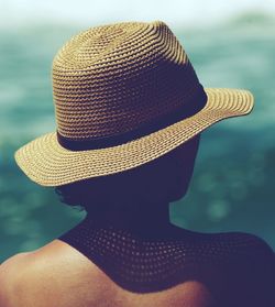 Rear view of woman wearing hat against sea