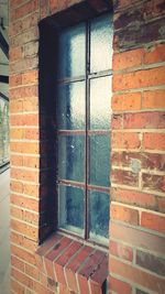 Close-up of window on brick wall