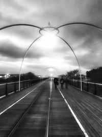 Railroad tracks in city against sky