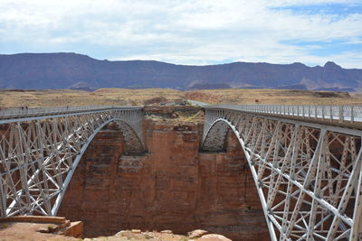 Arch bridge against sky