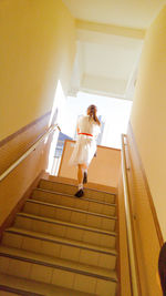 Low angle view of boy on steps