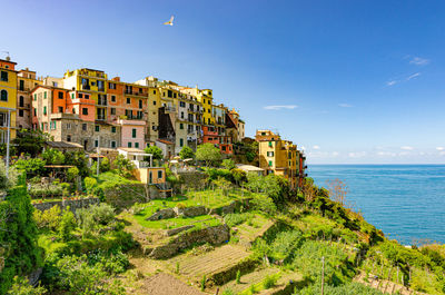 Panoramic shot of buildings by sea against sky