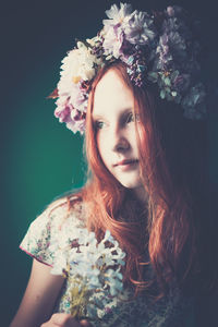 Portrait of young girl wearing floral garland