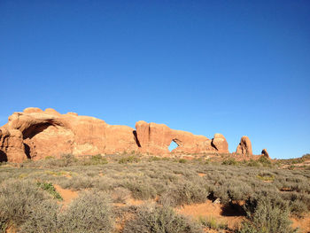 Scenic view of mountains against clear blue sky