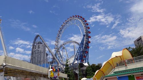Low angle view of ferris wheel against sky