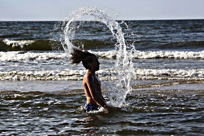 Woman jumping on beach