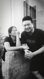 Portrait of smiling young couple sitting outdoors