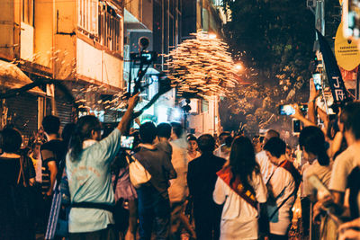 People on city street at night