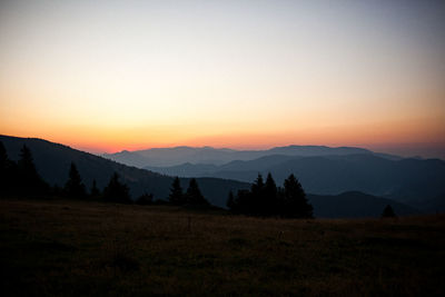 Scenic view of silhouette mountains against sky during sunset