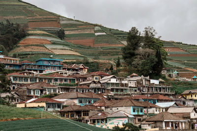 Buildings in town against sky