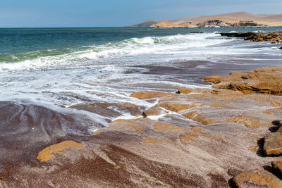 Scenic view of sea shore against sky