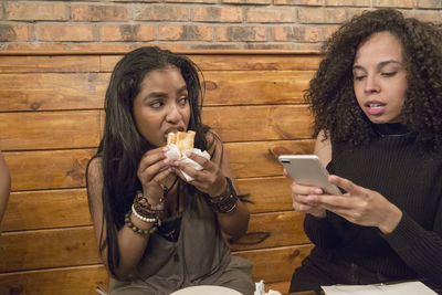 Friends at a restaurant in queens, new york