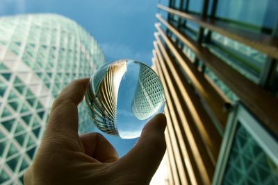 Close-up of hand holding crystal ball