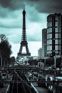 Eiffel tower against cloudy sky