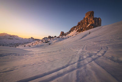 Scenic view of snow covered mountain against sky during sunset