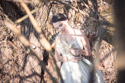 Bride standing by dry plants