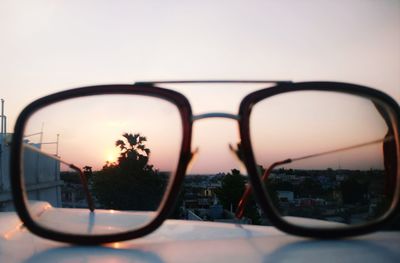 Close-up of sunglasses on side-view mirror