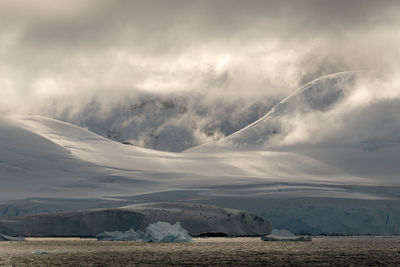 Scenic view of mountains against sky during winter