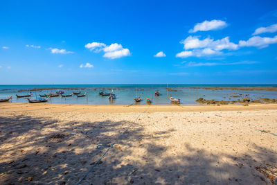 Scenic view of beach against blue sky