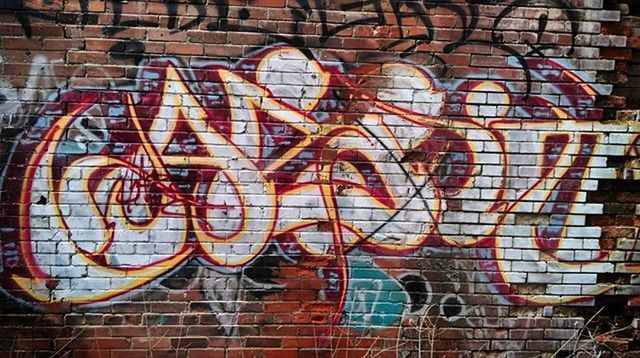 graffiti, art and craft, creativity, art, built structure, architecture, building exterior, wall - building feature, brick wall, street art, human representation, text, multi colored, wall, outdoors, mural, communication, vandalism, day