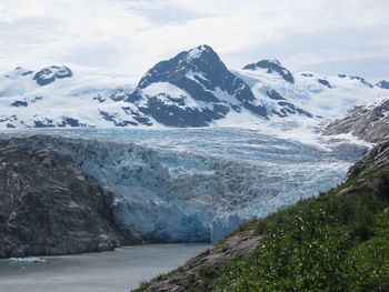 Scenic view of mountains against cloudy sky