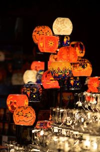 Illuminated lanterns hanging against sky at night