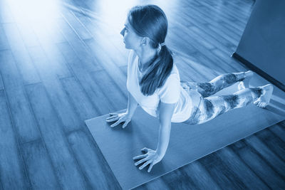 Young woman sitting on floor