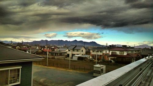 High angle view of town against cloudy sky