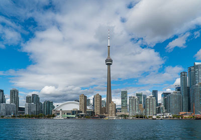 View of buildings in city against cloudy sky