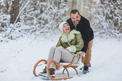 Portrait of happy man with snow during winter