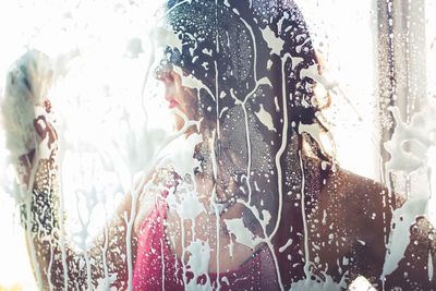 Mid adult woman cleaning house window