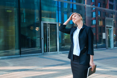 Successful businesswoman taking notes while walking outdoors. business woman