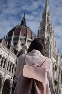 Rear view of woman against hungarian parliament building